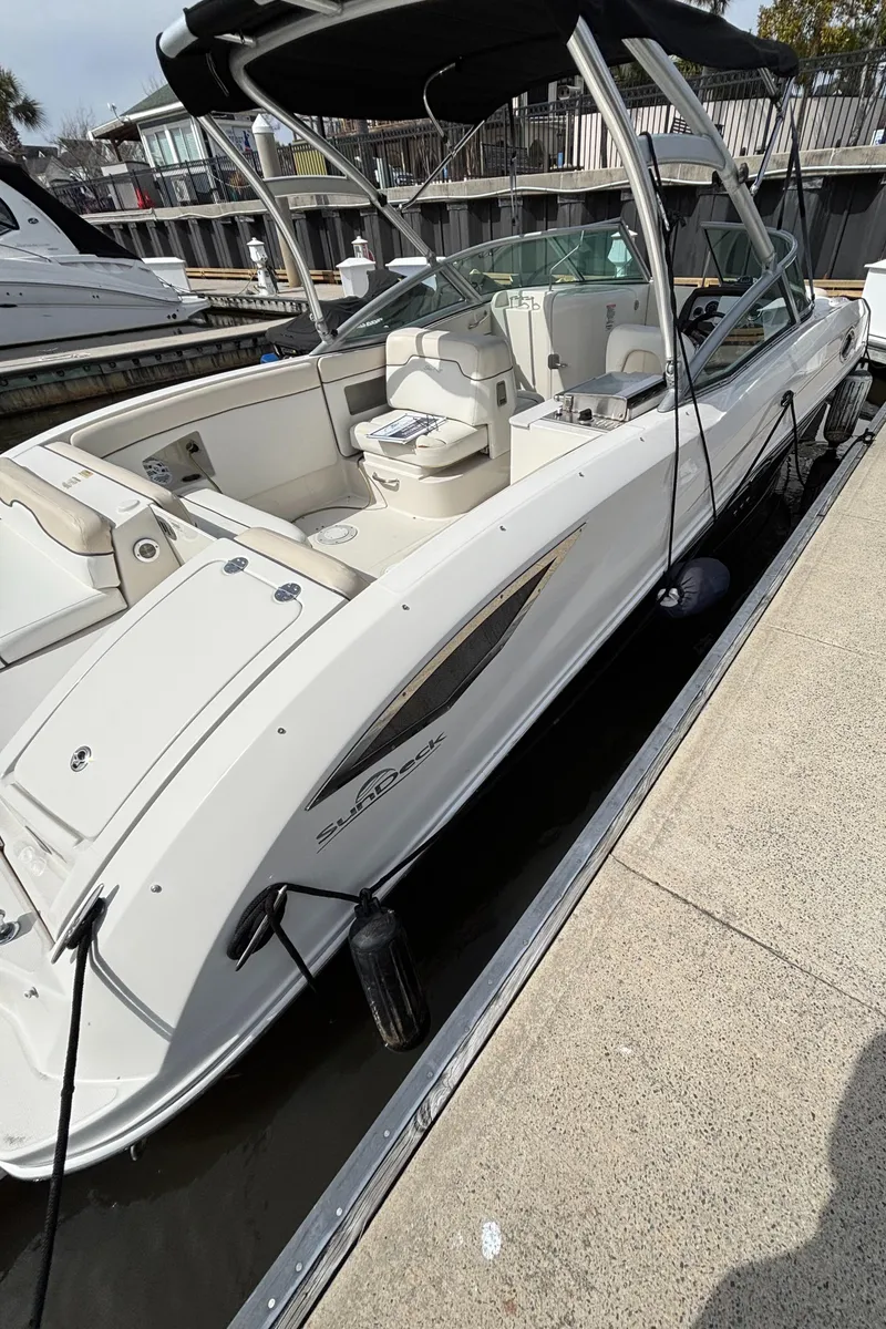 Slide: The Image of 2008 Sea Ray 290 Sundeck boat docked, featuring sleek design and spacious seating. - 9