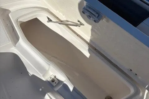Slide: The Image of 2021 Robalo R200 Center Console storage compartment, open and empty. - 11