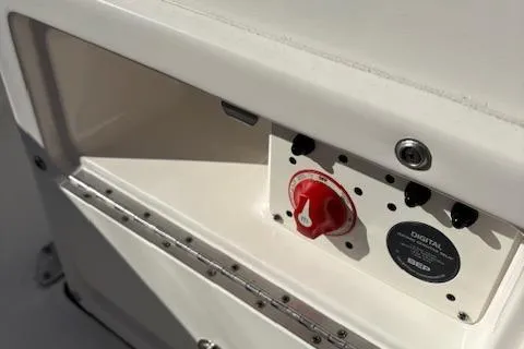 Slide: The Image of 2021 Robalo R200 Center Console boat control panel with red switch and digital display. - 7