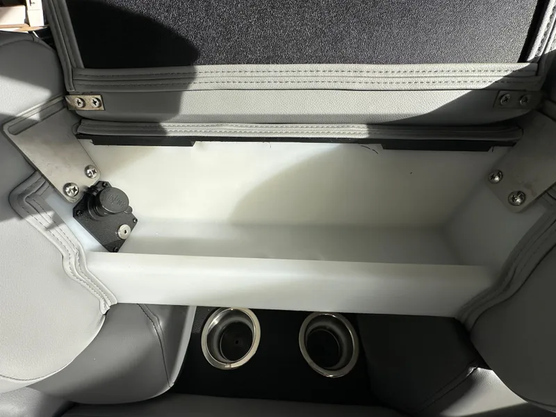 Slide: The Image of Storage compartment in 2025 South Bay 523RS boat, featuring cup holders and sleek design. - 10