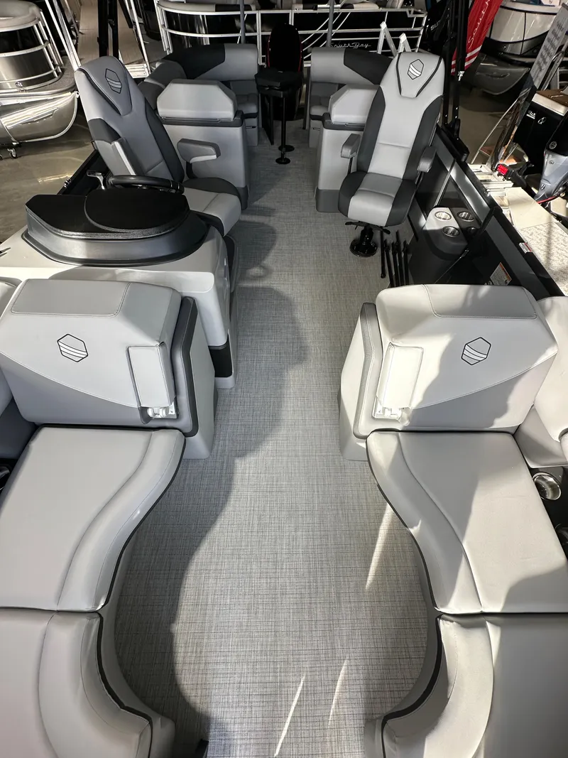 Slide: The Image of 2025 South Bay 523RS boat interior with modern gray seating and sleek design. - 12