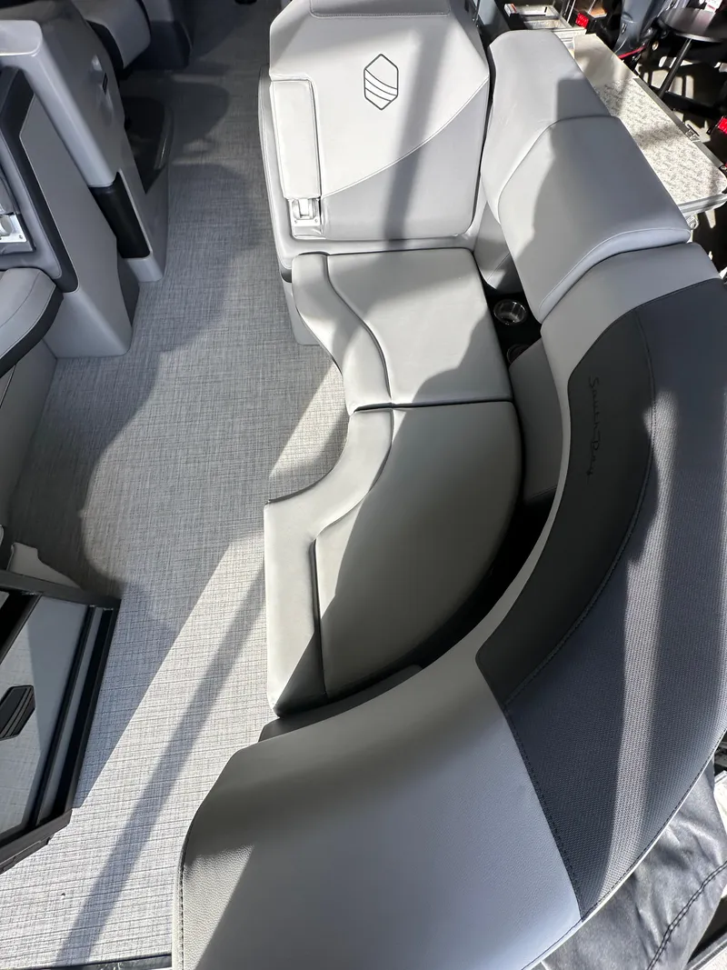 Slide: The Image of 2025 South Bay 523RS boat interior with modern gray seating and carpeted flooring. - 13