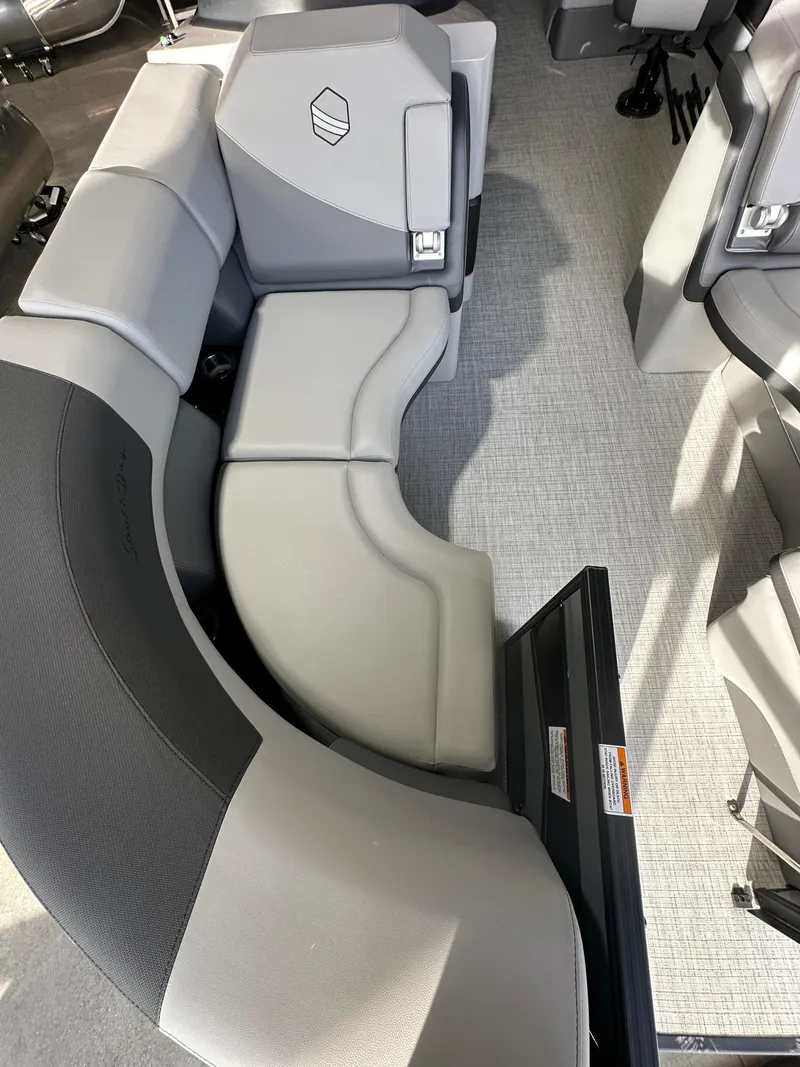 Slide: The Image of 2025 South Bay 523RS boat interior with modern gray seating and carpeted flooring. - 2