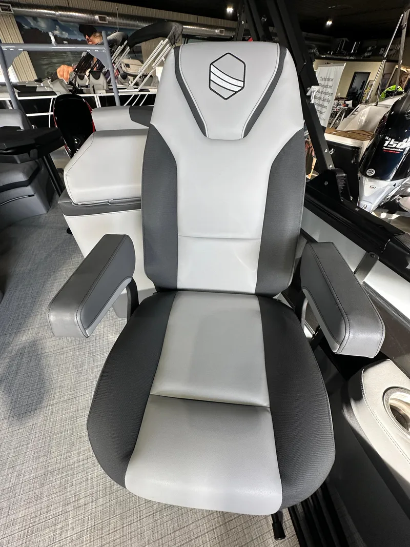 Slide: The Image of 2025 South Bay 523RS boat seat, gray and black design, in a showroom setting. - 4