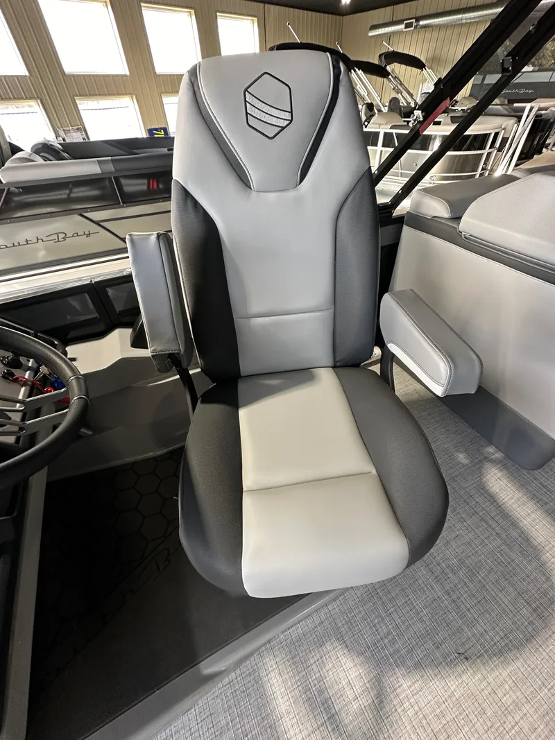Slide: The Image of 2025 South Bay 523RS boat seat, gray and black design, in a modern interior setting. - 6