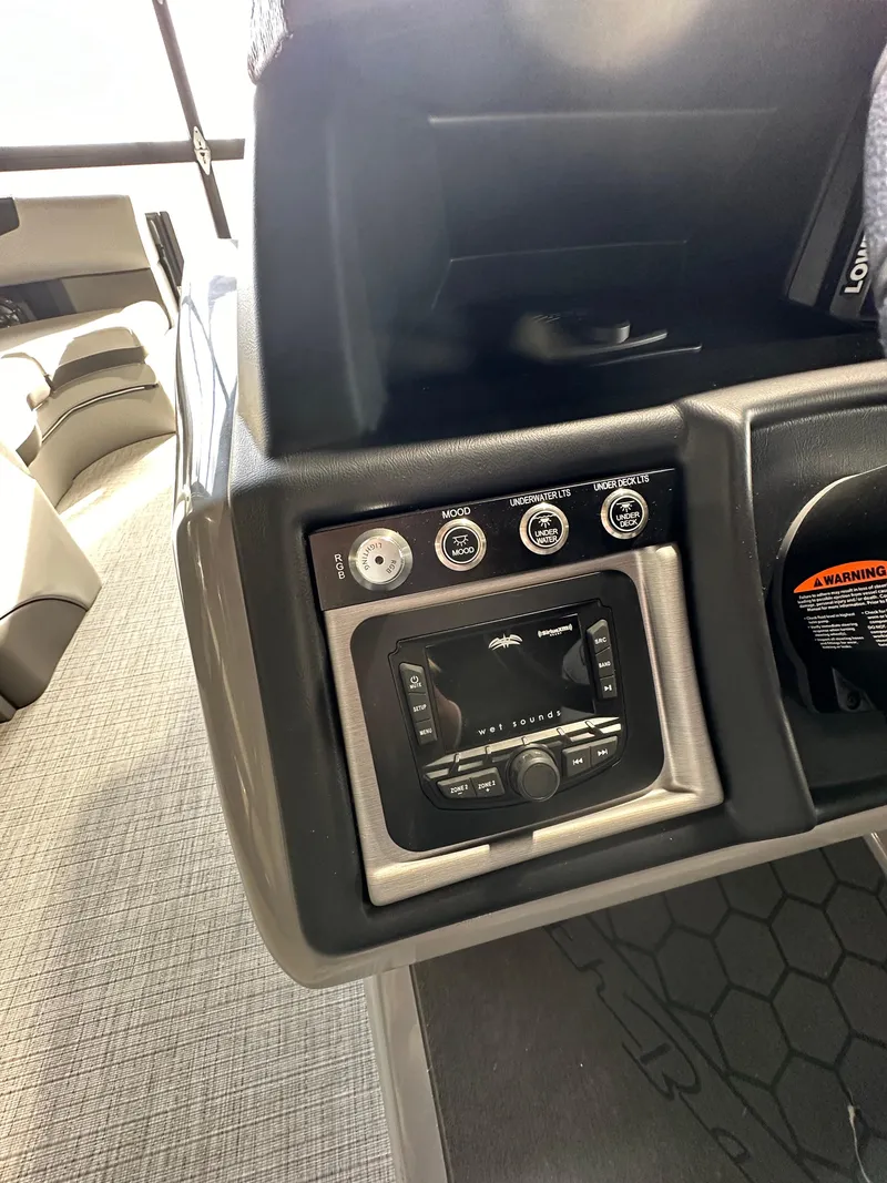 Slide: The Image of 2025 South Bay 523RS boat dashboard with control panel and audio system. - 7