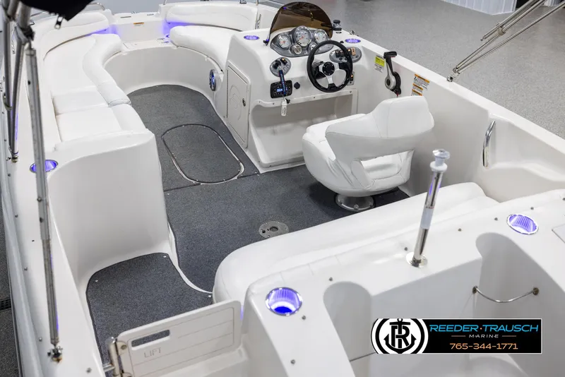 Slide: The Image of 2015 Starcraft 1915 Limited OB boat interior with white seating and modern dashboard. - 11