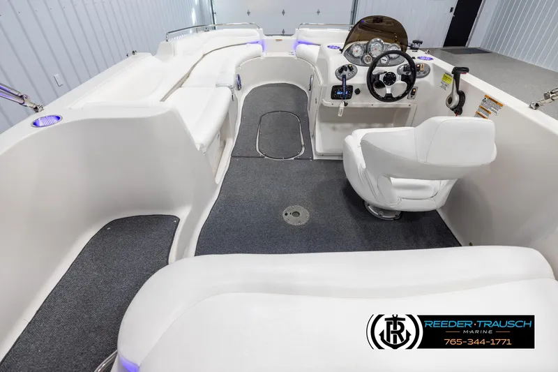 Slide: The Image of 2015 Starcraft 1915 Limited OB boat interior with white seating and steering console. - 13