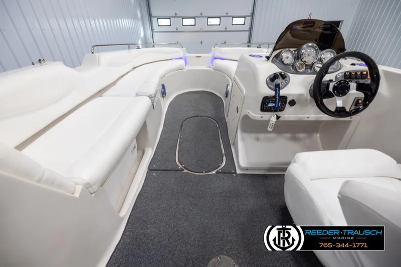 Slide: The Image of 2015 Starcraft 1915 Limited OB boat interior with white seating and modern dashboard. - 14