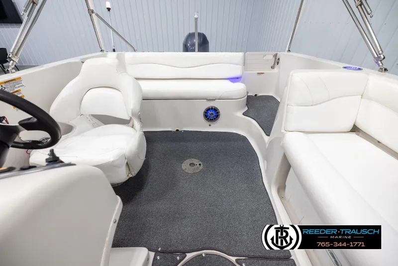 Slide: The Image of Interior of 2015 Starcraft 1915 Limited OB boat with white seating and carpeted floor. - 17