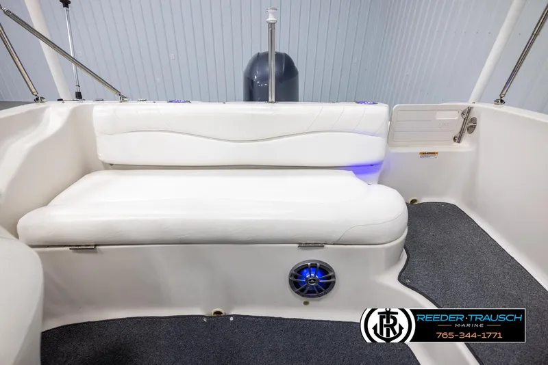 Slide: The Image of 2015 Starcraft 1915 Limited OB boat interior with white seating and blue LED lighting. - 18