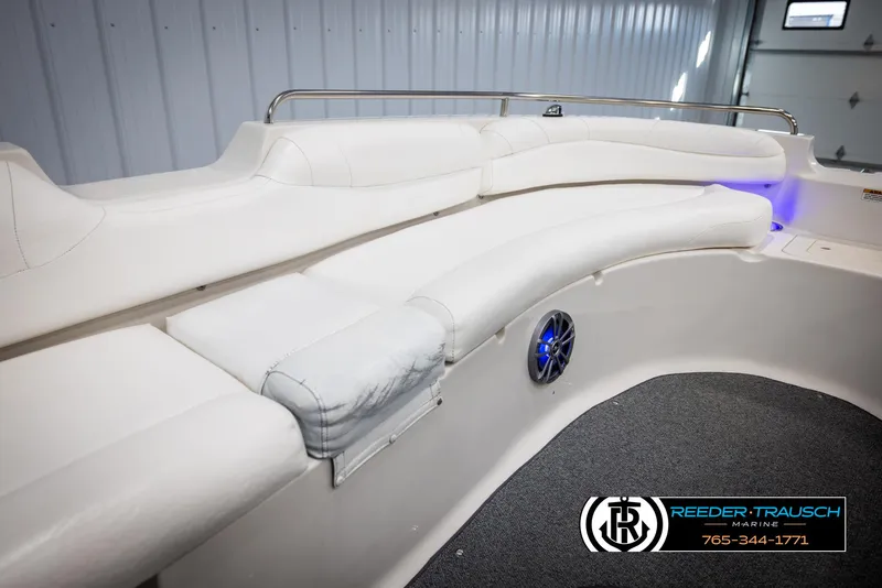 Slide: The Image of 2015 Starcraft 1915 Limited OB boat interior with white seating and blue accent lighting. - 19