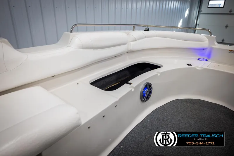 Slide: The Image of 2015 Starcraft 1915 Limited OB boat interior with white seating and speaker. - 21