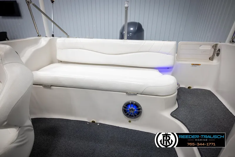 Slide: The Image of 2015 Starcraft 1915 Limited OB boat interior with white seating and blue LED speaker. - 22