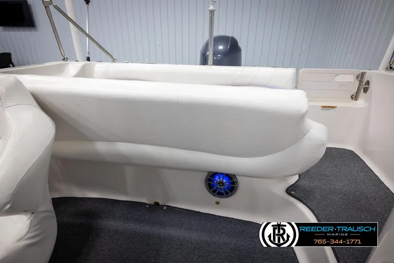 Slide: The Image of 2015 Starcraft 1915 Limited OB boat interior with white seating and blue speaker. - 23