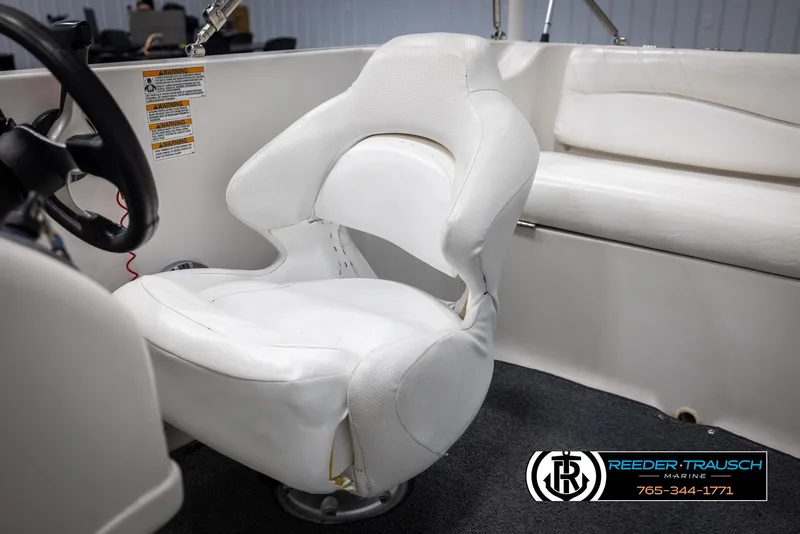 Slide: The Image of 2015 Starcraft 1915 Limited OB boat interior with white captain's chair. - 24
