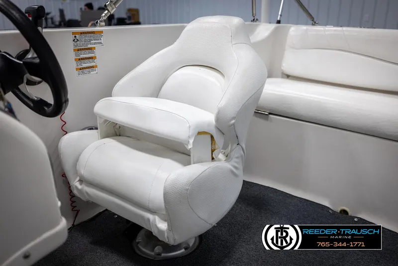 Slide: The Image of 2015 Starcraft 1915 Limited OB boat interior with white captain's chair and seating. - 25