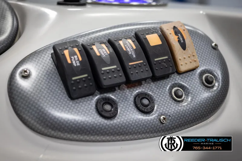 Slide: The Image of Control panel of 2015 Starcraft 1915 Limited OB boat with switches and buttons. - 32