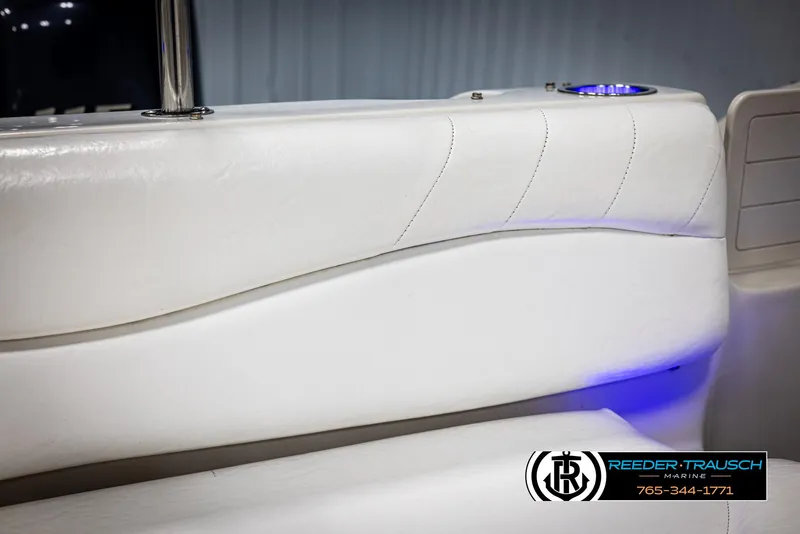 Slide: The Image of 2015 Starcraft 1915 Limited OB boat interior with white seating and blue LED lighting. - 35