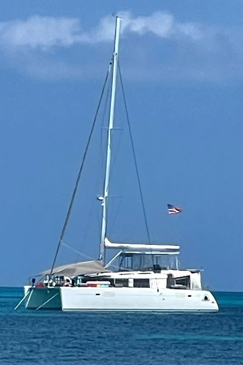 Slide: The Image of 2016 Lagoon 450 F catamaran sailing on clear blue waters. - 1