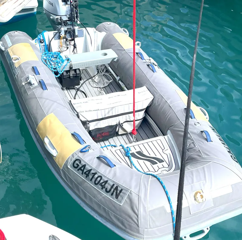 Slide: The Image of Inflatable dinghy with motor, docked on water, associated with Lagoon 450 F, 2016 model. - 10