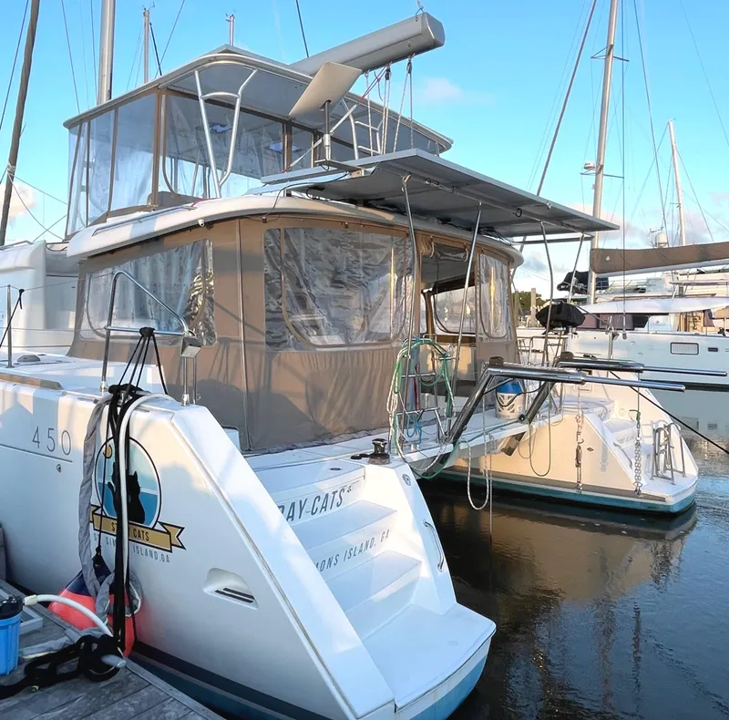 Slide: The Image of 2016 Lagoon 450 F catamaran docked at marina, rear view. - 12