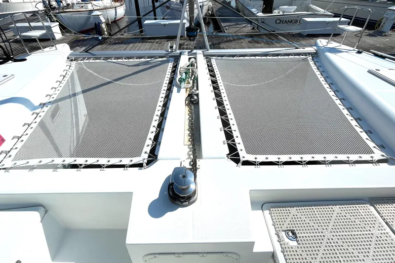 Slide: The Image of 2016 Lagoon 450 F catamaran deck with netting and anchor chain. - 15