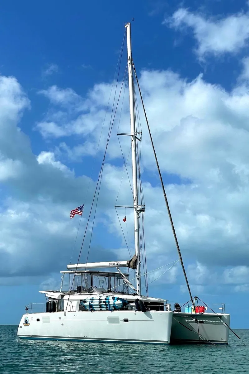 Slide: The Image of 2016 Lagoon 450 F catamaran sailing under a blue sky with clouds. - 2