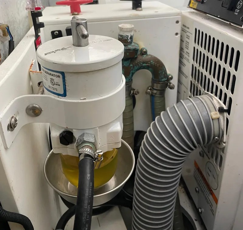 Slide: The Image of Engine compartment of a 2016 Lagoon 450 F with fuel filter and hoses. - 22