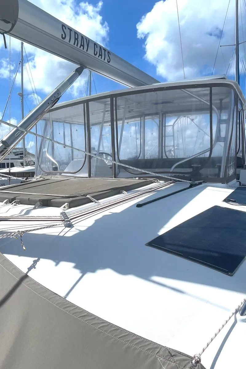 Slide: The Image of 2016 Lagoon 450 F catamaran with "Stray Cats" branding under a clear blue sky. - 23