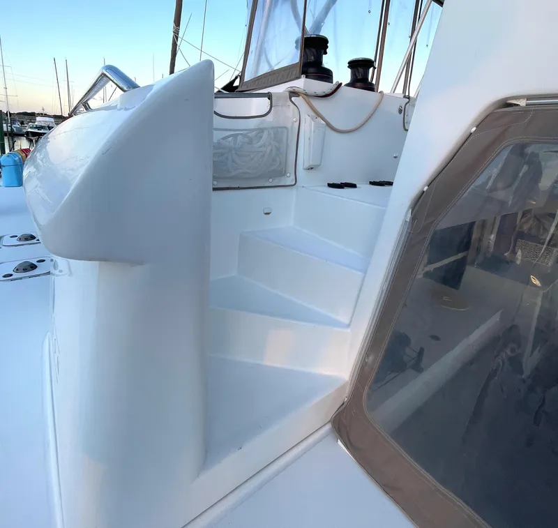Slide: The Image of 2016 Lagoon 450 F yacht deck with steps and winches, docked at marina. - 25