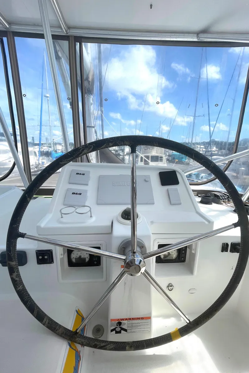 Slide: The Image of Helm of 2016 Lagoon 450 F catamaran with clear sky view. - 27