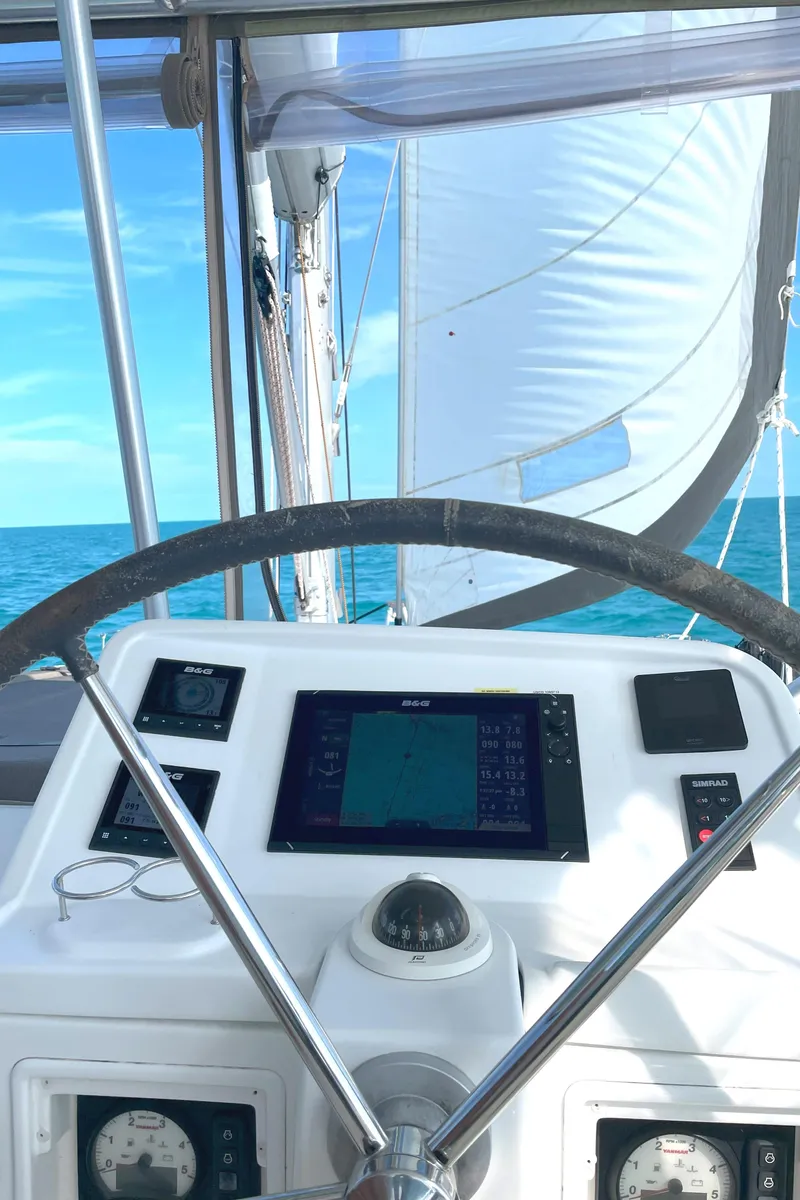 Slide: The Image of Steering wheel and navigation panel of 2016 Lagoon 450 F catamaran at sea. - 28
