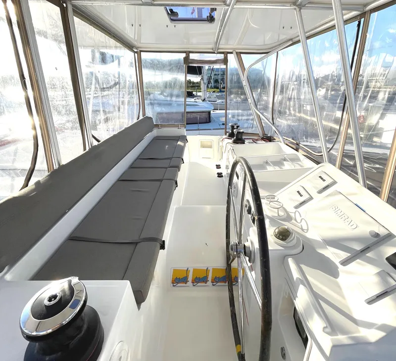 Slide: The Image of Interior view of 2016 Lagoon 450 F catamaran with steering wheel and seating area. - 29