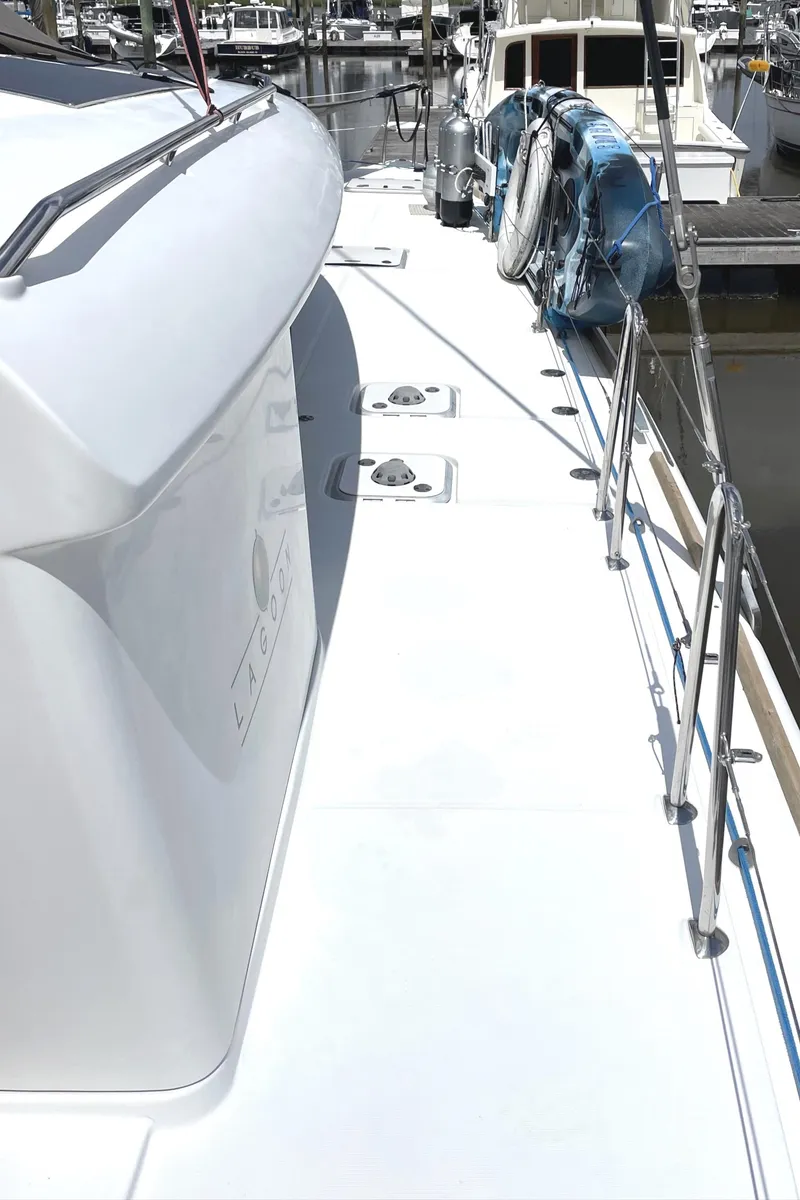 Slide: The Image of 2016 Lagoon 450 F yacht deck with sleek design and marina view. - 31