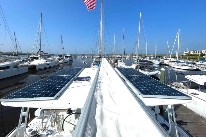 Slide: The Image of Lagoon 450 F catamaran with solar panels docked in a marina, 2016 model. - 36