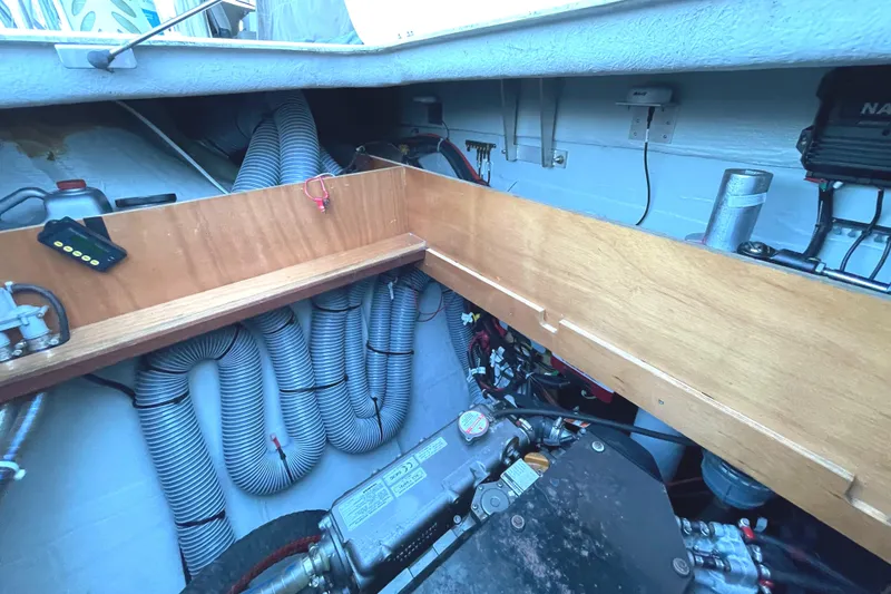 Slide: The Image of Engine compartment of a 2016 Lagoon 450 F catamaran, showcasing mechanical components and wiring. - 48