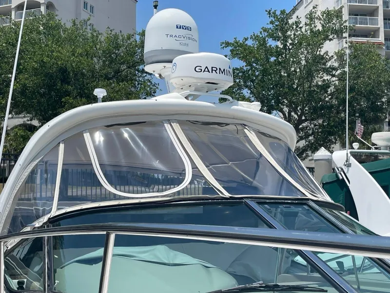 Slide: The Image of 2010 Sea Ray 350 Sundancer with Garmin radar, docked near buildings and trees. - 14