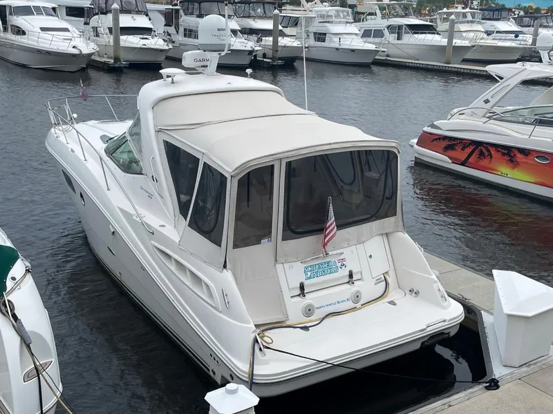 Slide: The Image of 2010 Sea Ray 350 Sundancer docked at marina, surrounded by other boats. - 15