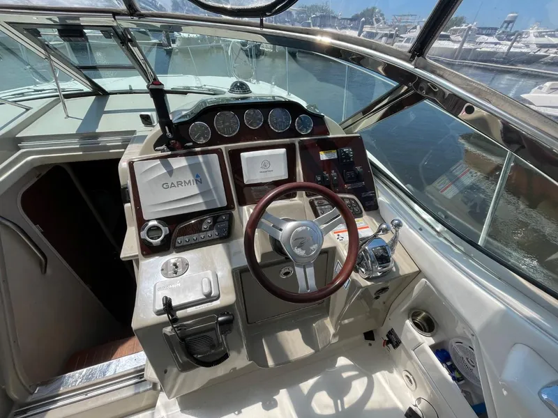 Slide: The Image of Cockpit of 2010 Sea Ray 350 Sundancer with Garmin navigation system and steering wheel. - 16