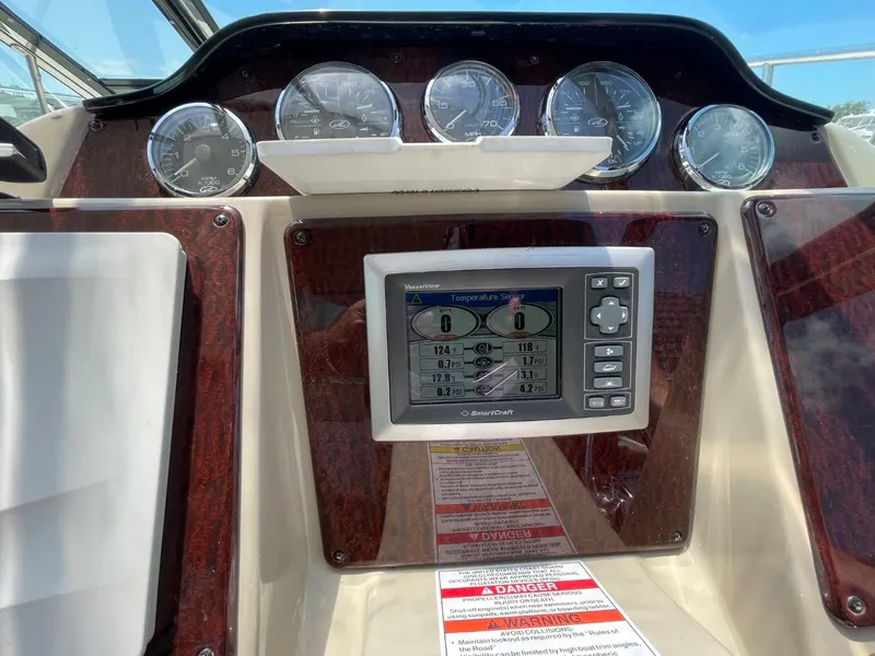 Slide: The Image of Dashboard of a 2010 Sea Ray 350 Sundancer with gauges and navigation display. - 21