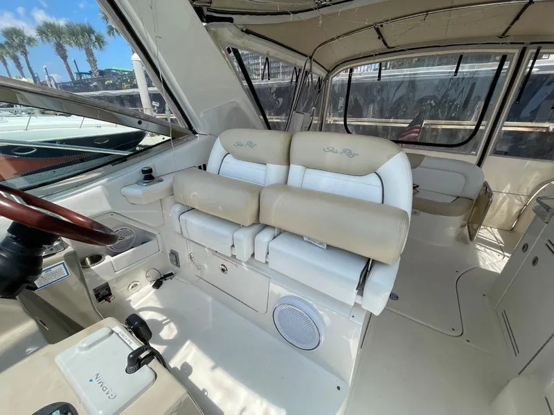 Slide: The Image of 2010 Sea Ray 350 Sundancer interior with beige seating and helm station. - 22
