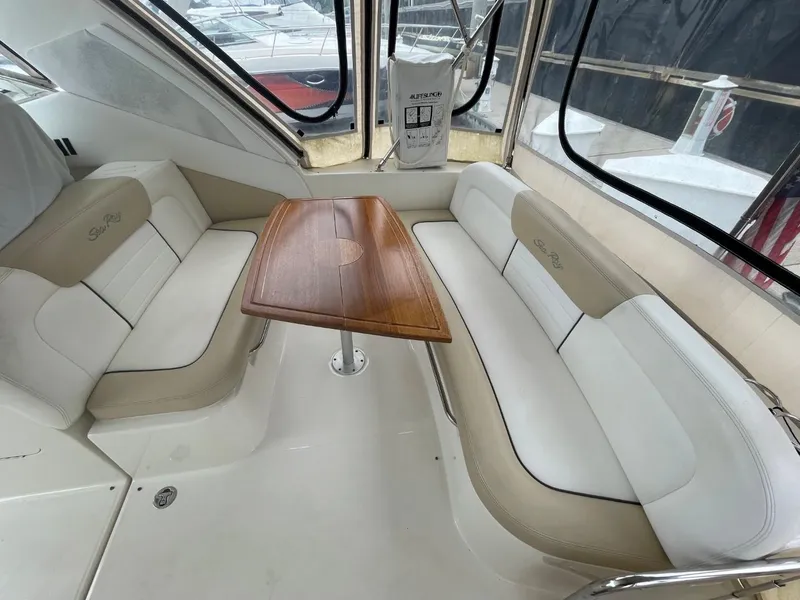 Slide: The Image of Interior seating area of a 2010 Sea Ray 350 Sundancer yacht with wooden table. - 24