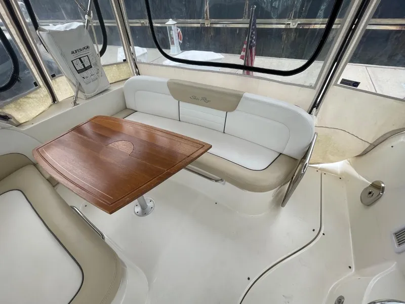 Slide: The Image of 2010 Sea Ray 350 Sundancer interior with seating and wooden table. - 25