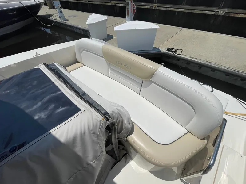 Slide: The Image of 2010 Sea Ray 350 Sundancer boat with beige and white seating at a dock. - 26