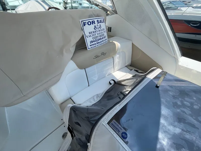 Slide: The Image of 2010 Sea Ray 350 Sundancer interior with "For Sale" sign, beige and white seating. - 27