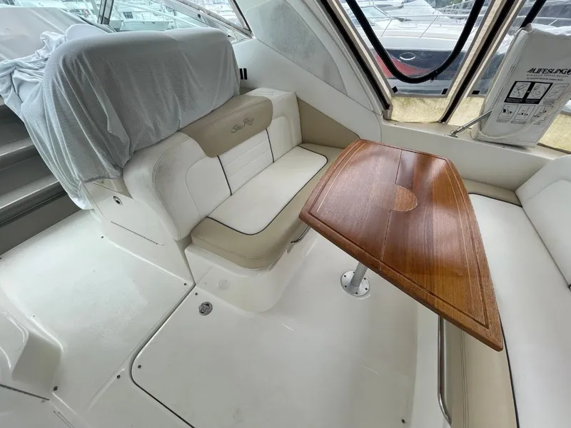 Slide: The Image of Interior of 2010 Sea Ray 350 Sundancer with seating and wooden table. - 28