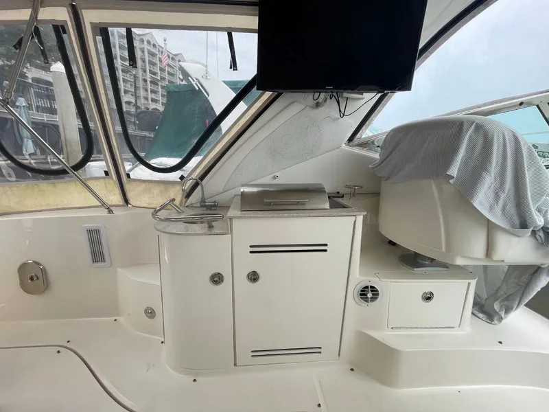 Slide: The Image of Interior of 2010 Sea Ray 350 Sundancer yacht with covered seating and cabinetry. - 29