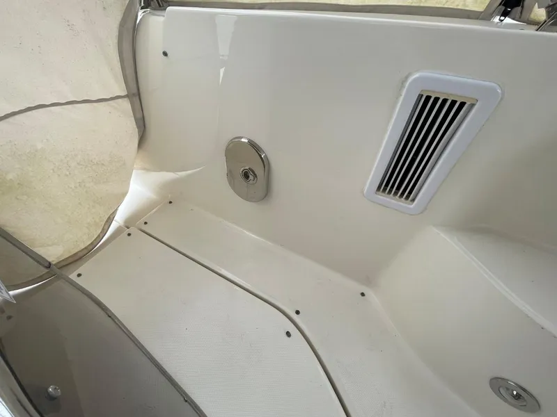 Slide: The Image of Interior view of 2010 Sea Ray 350 Sundancer boat, featuring sleek white paneling. - 31