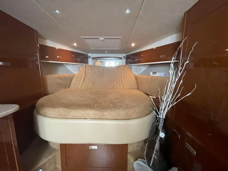 Slide: The Image of Interior cabin of 2010 Sea Ray 350 Sundancer with cozy bed and wooden finish. - 33